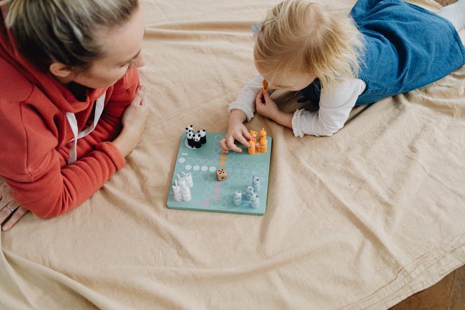 Mother and daughter playing board game together learning resource management