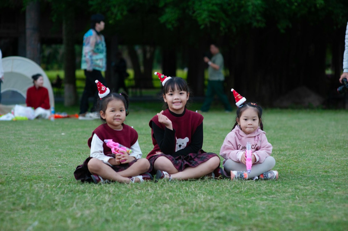 Eight players gathered around table playing board games with engaged expressions