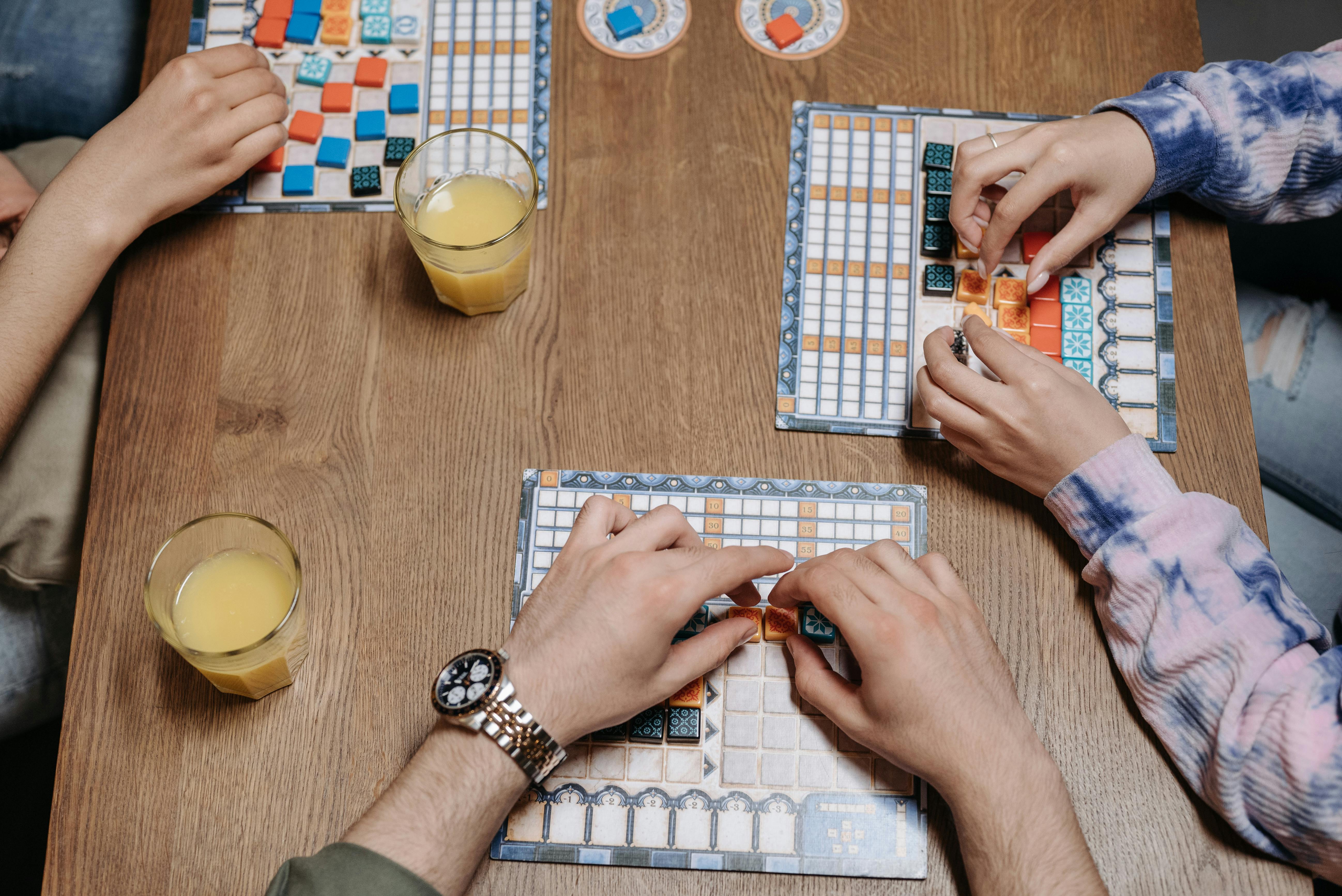 Adults playing the Azul board game — a classic example of strategy games for grown-ups