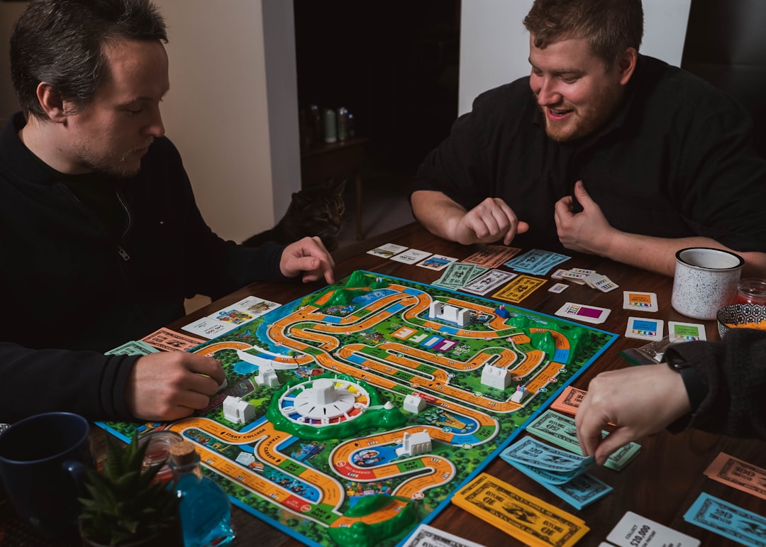 A group of friends gathered around a table playing a classic board game together