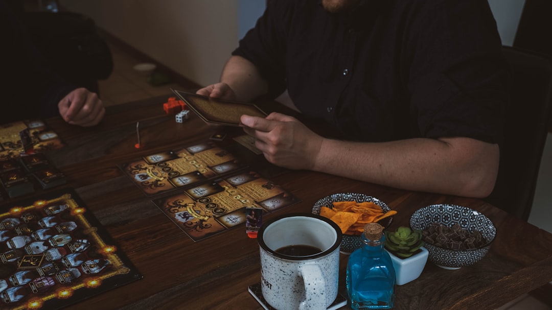 Friends laughing together at a table at a social gathering with games