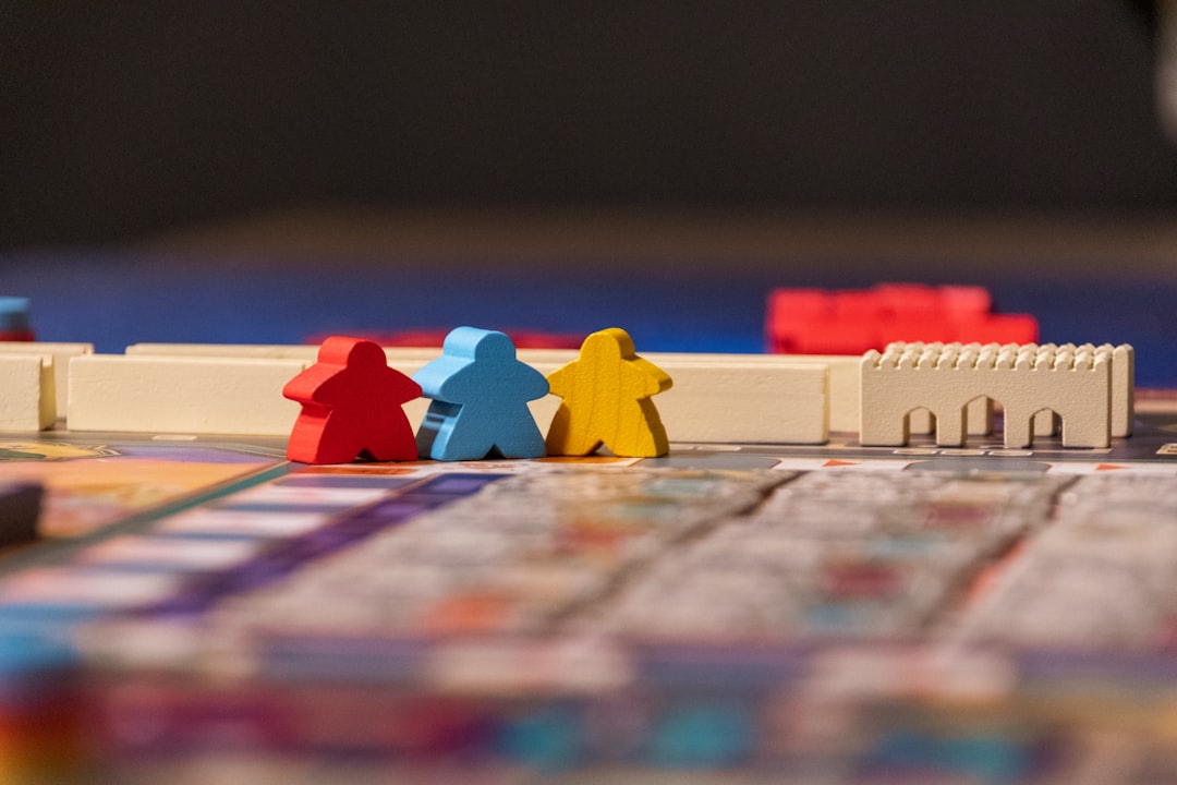 Board game components including meeples and resource tokens arranged on a strategy game board