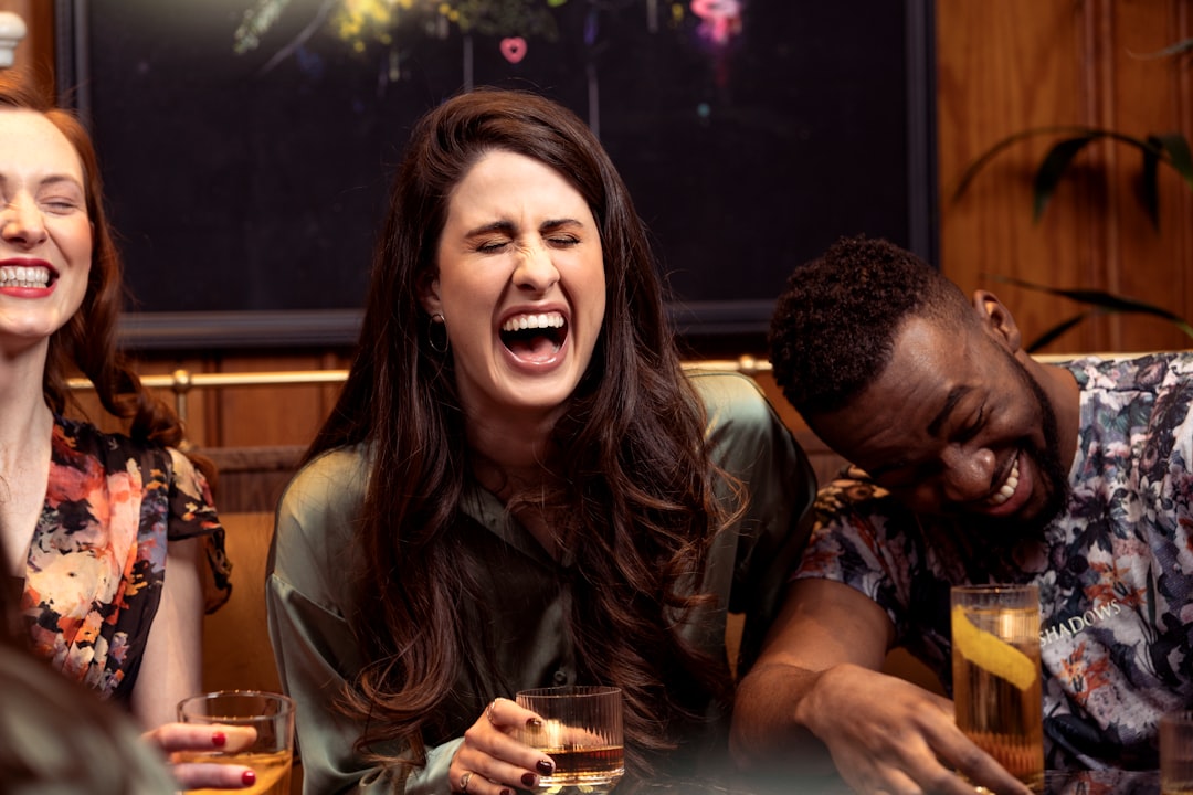 Group of adults laughing around a table playing board games at a party