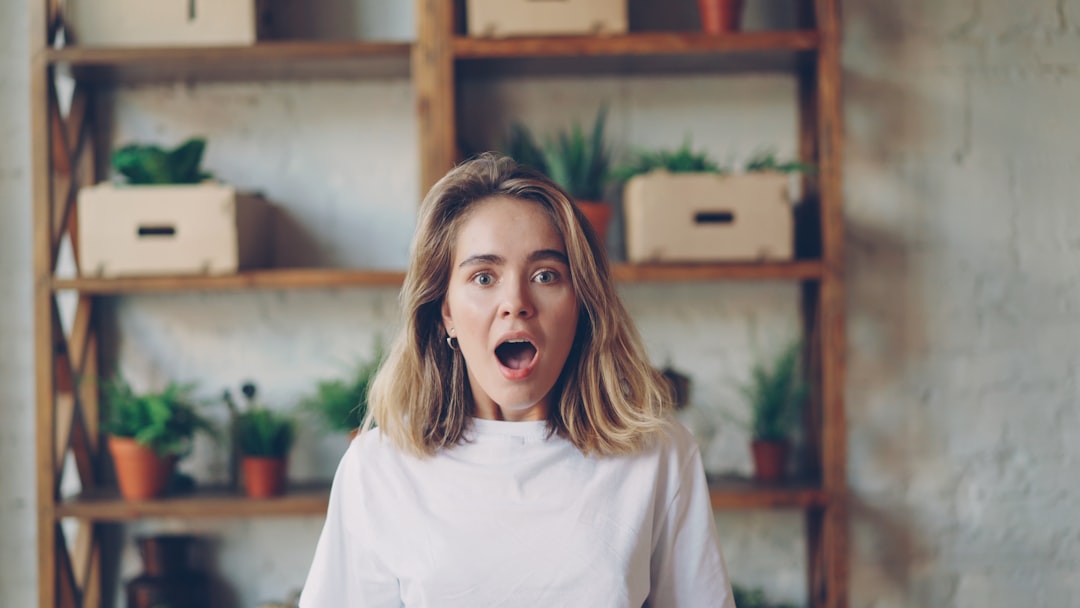 A surprised adult looking genuinely engaged while playing a board game at a table