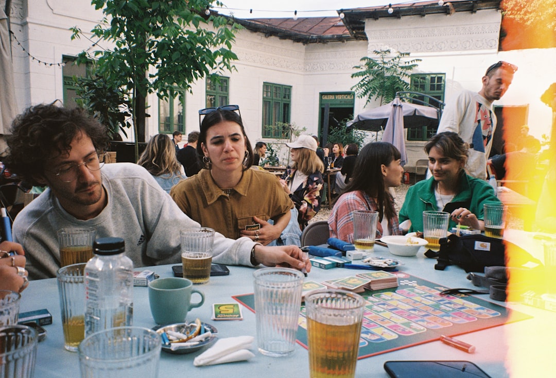 A large group of friends gathered around a table for board game night