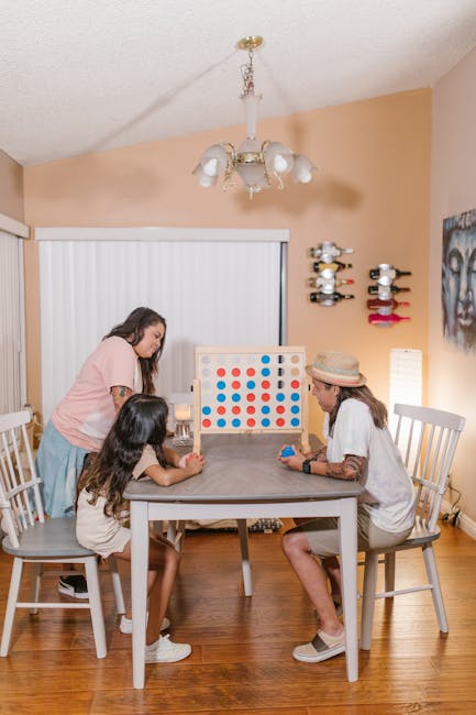 A family playing a board game together around the table.