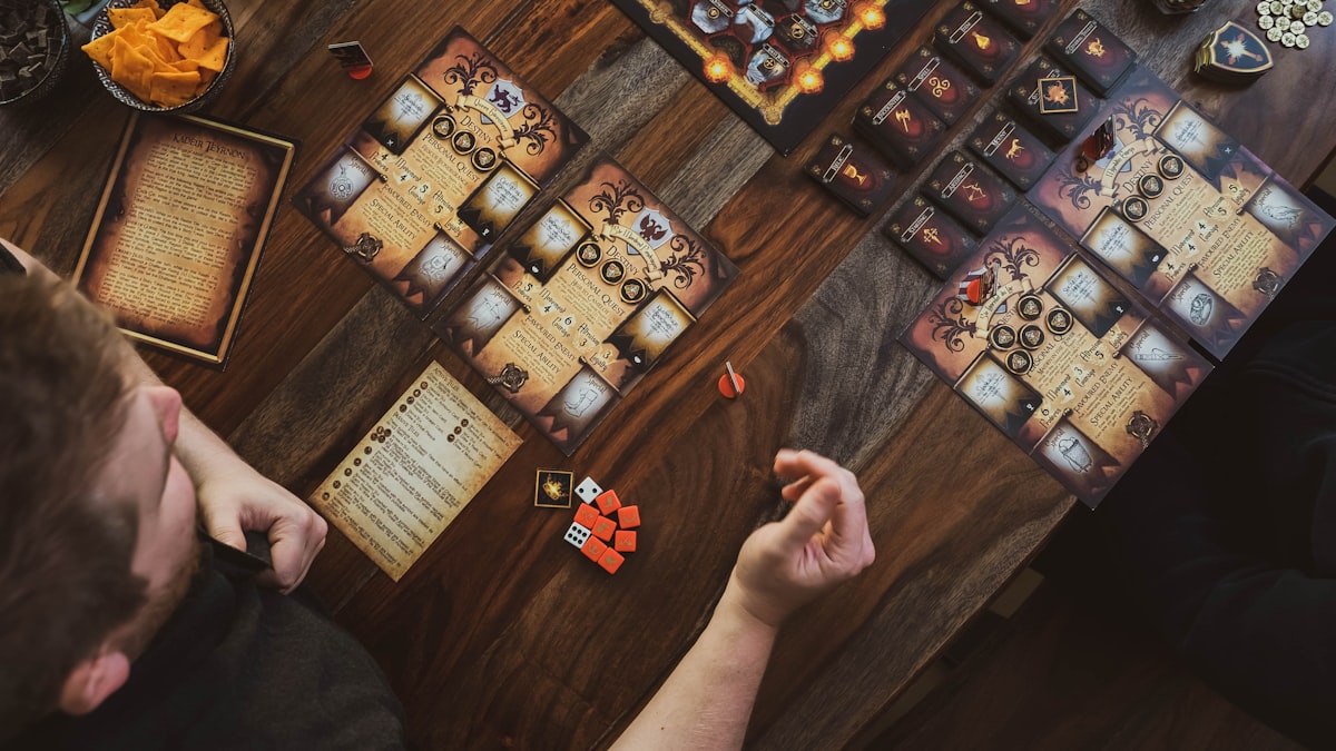 A top-down view of friends gathered around a table playing a board game together
